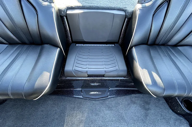 Slide: The Image of 2026 Skeeter ZXE21 interior seating with black leather upholstery and center console. - 26