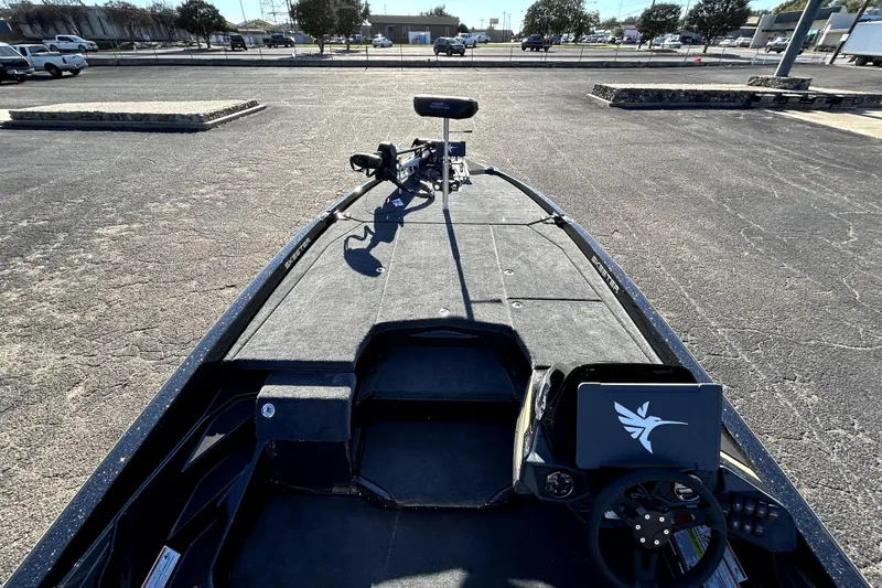 Slide: The Image of 2026 Skeeter ZXE21 fishing boat in a parking lot, showcasing deck and steering console. - 37