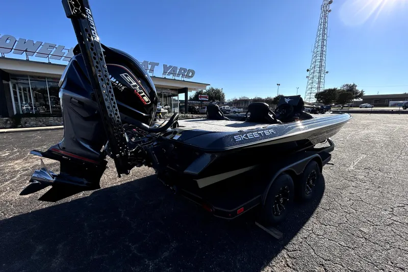 Slide: The Image of 2026 Skeeter ZXE21 boat with powerful engine, parked outside dealership. - 6