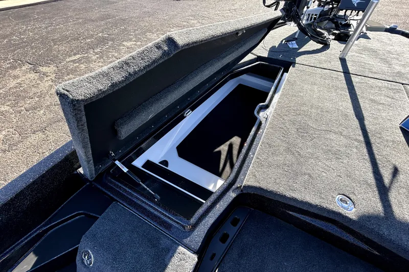 Slide: The Image of Open storage compartment on 2026 Skeeter ZXE21 boat, showcasing spacious interior design. - 12