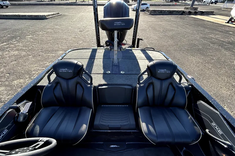 Slide: The Image of 2026 Skeeter ZXE21 boat interior with black seats and steering wheel. - 25