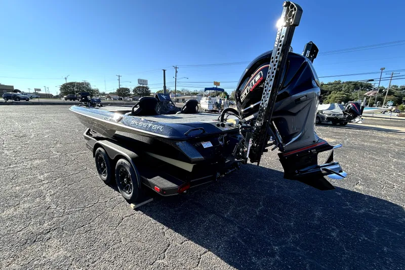 Slide: The Image of 2026 Skeeter ZXE21 boat with powerful engine, parked on asphalt under clear blue sky. - 4