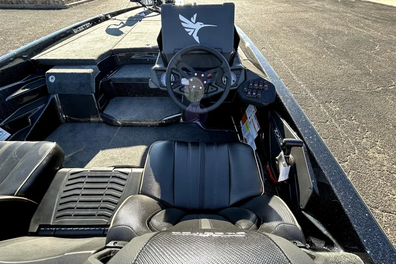 Slide: The Image of 2026 Skeeter ZXE21 boat interior with steering wheel and control panel. - 38