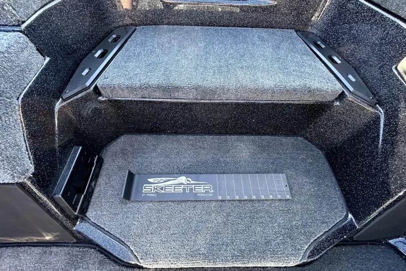 Slide: The Image of Interior of 2026 Skeeter ZXE21 boat with carpeted flooring and branded measuring board. - 21