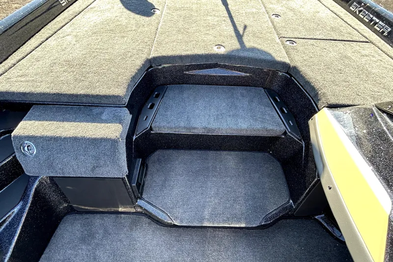 Slide: The Image of 2026 Skeeter ZXE21 boat interior with carpeted deck and storage compartments. - 19