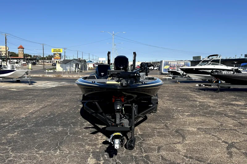 Slide: The Image of 2026 Skeeter ZXE21 boat on display in a parking lot under clear blue skies. - 2
