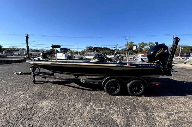 Slide: The Image of 2026 Skeeter ZXE21 boat on trailer in parking lot, clear blue sky. - 3