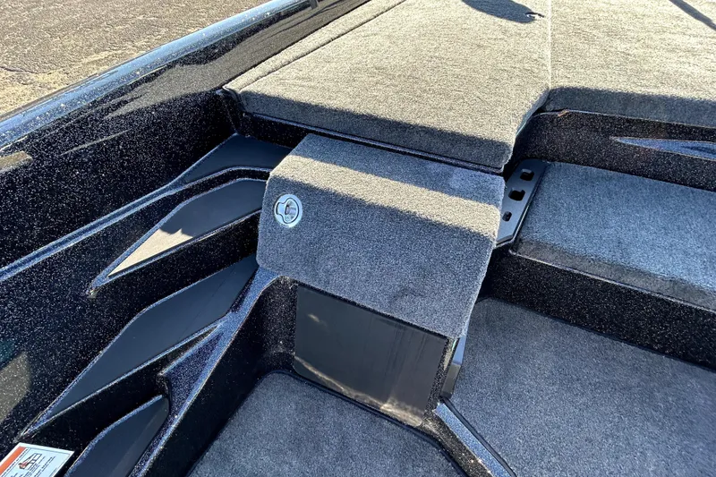 Slide: The Image of 2026 Skeeter ZXE21 boat interior with carpeted deck and storage compartment. - 22