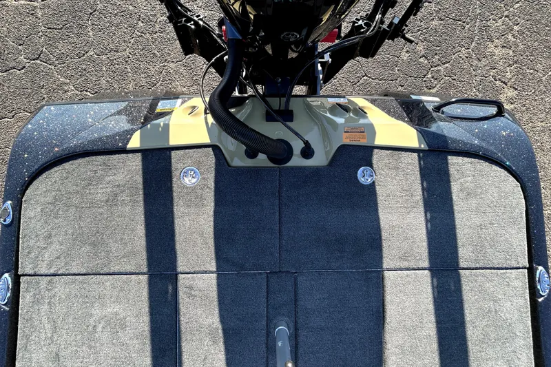 Slide: The Image of Top view of 2026 Skeeter ZXE21 boat deck with motor and carpeted surface. - 35