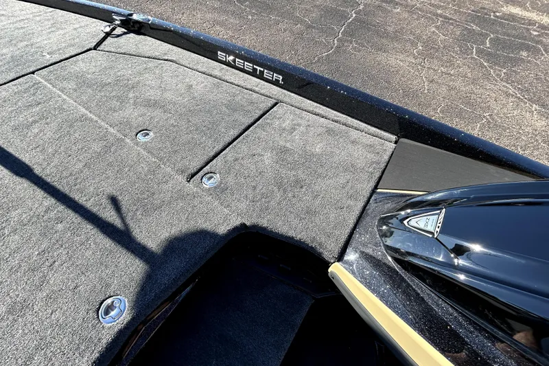 Slide: The Image of 2026 Skeeter ZXE21 boat deck with carpeted surface and storage compartments. - 17