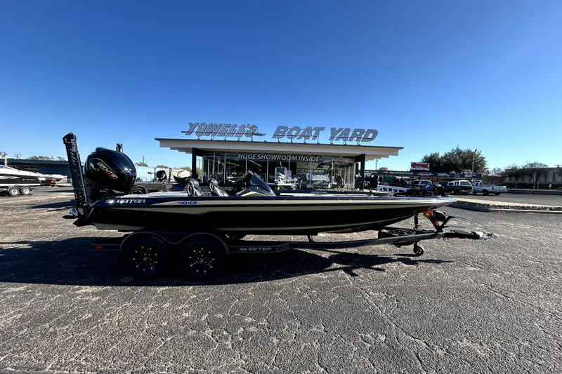 Slide: The Image of 2026 Skeeter ZXE21 boat at Yonell's Boat Yard under clear blue sky. - 0