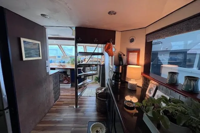 Slide: The Image of Interior of 1989 Hatteras 70 Cockpit Motor Yacht with modern decor and natural lighting. - 10