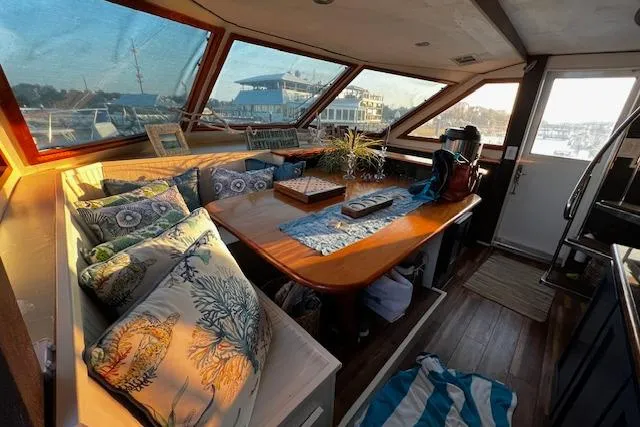 Slide: The Image of Interior of 1989 Hatteras 70 Cockpit Motor Yacht with cozy seating and nautical decor. - 11