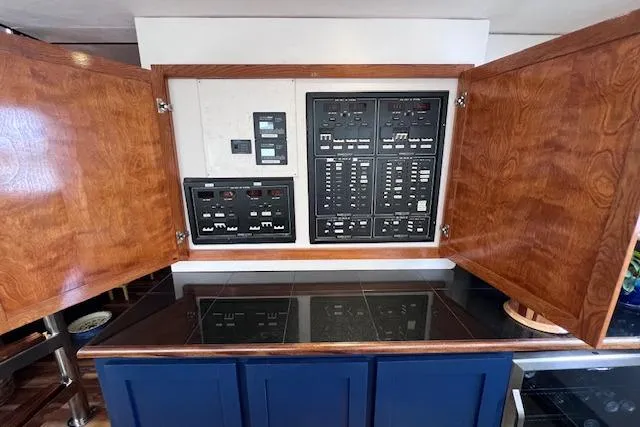 Slide: The Image of Electrical panel inside 1989 Hatteras 70 Cockpit Motor Yacht with wooden cabinetry. - 16