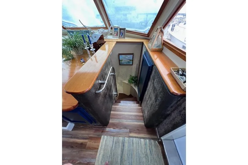 Slide: The Image of Interior of 1989 Hatteras 70 Cockpit Motor Yacht with wooden stairs and decor. - 18