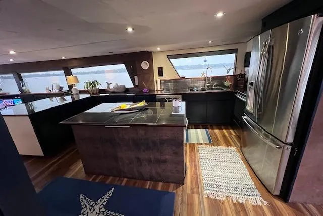 Slide: The Image of Luxurious kitchen interior of 1989 Hatteras 70 Cockpit Motor Yacht with modern appliances. - 19