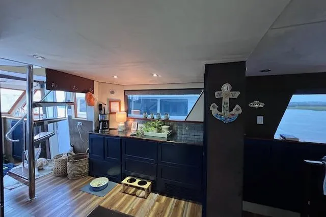 Slide: The Image of Interior of 1989 Hatteras 70 Cockpit Motor Yacht with modern kitchen and nautical decor. - 20