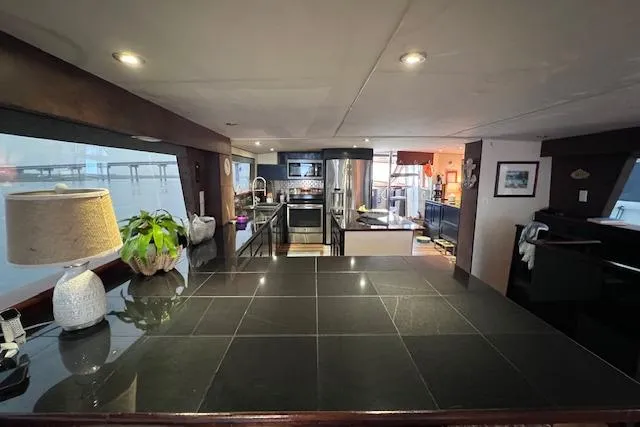 Slide: The Image of Interior of 1989 Hatteras 70 Cockpit Motor Yacht with modern kitchen and sleek design. - 22