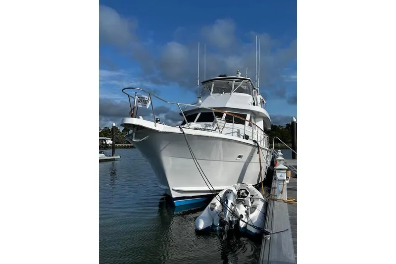 Slide: The Image of 1989 Hatteras 70 Cockpit Motor Yacht docked with inflatable boat. - 3