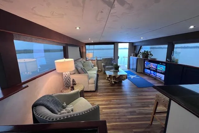 Slide: The Image of Luxurious interior of 1989 Hatteras 70 Cockpit Motor Yacht with elegant furnishings and scenic views. - 4