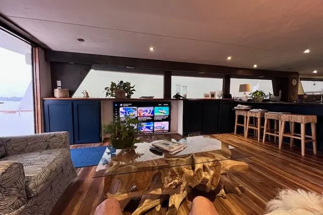 Slide: The Image of Luxurious interior of 1989 Hatteras 70 Cockpit Motor Yacht with modern decor and entertainment system. - 7