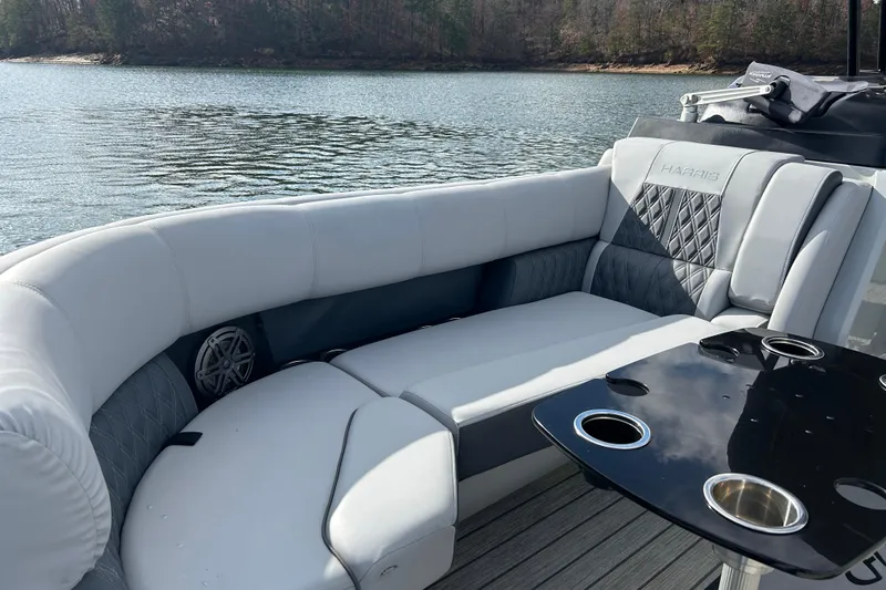 Slide: The Image of Luxurious seating on 2021 Harris Solstice 250 pontoon boat by a serene lake. - 17