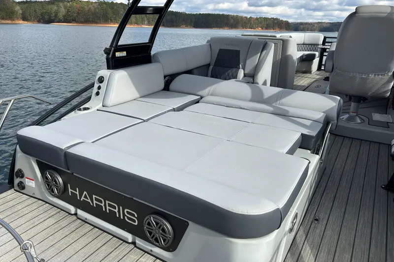 Slide: The Image of 2021 Harris Solstice 250 boat with spacious seating on a serene lake. - 19