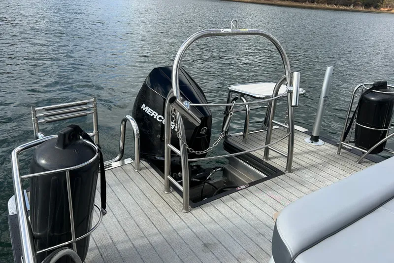 Slide: The Image of 2021 Harris Solstice 250 boat with Mercury engine on a calm lake. - 20