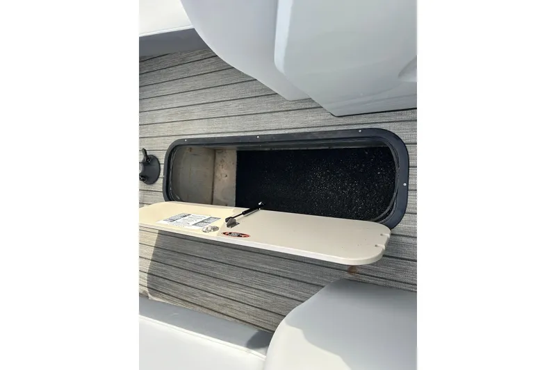 Slide: The Image of Open storage compartment on 2021 Harris Solstice 250 boat deck. - 23