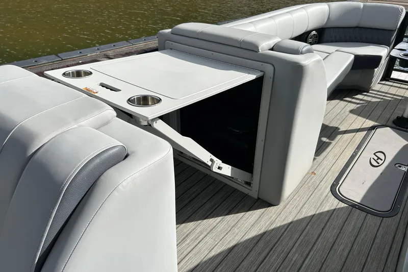 Slide: The Image of 2021 Harris Solstice 250 boat interior with gray seating and built-in cup holders. - 24