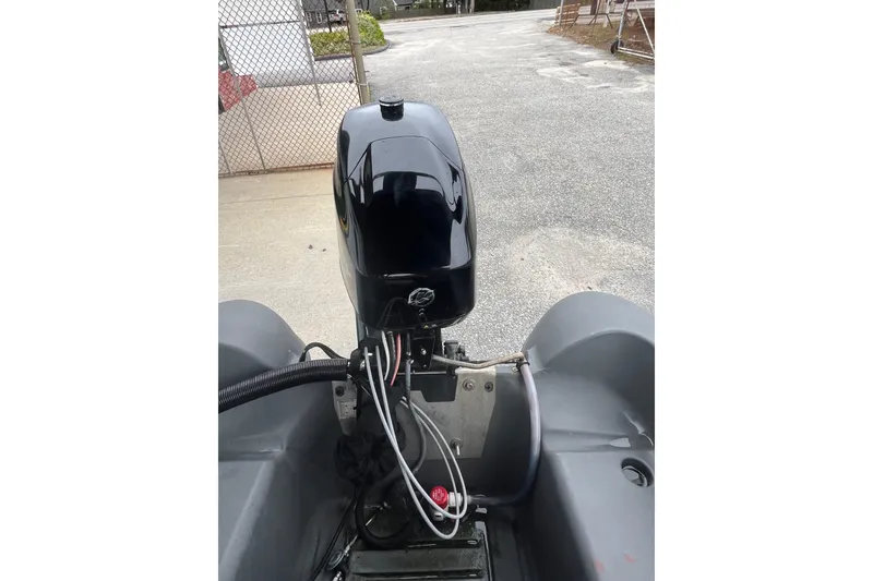 Slide: The Image of 2021 Whaly 435 R boat with outboard motor in a parking area. - 11