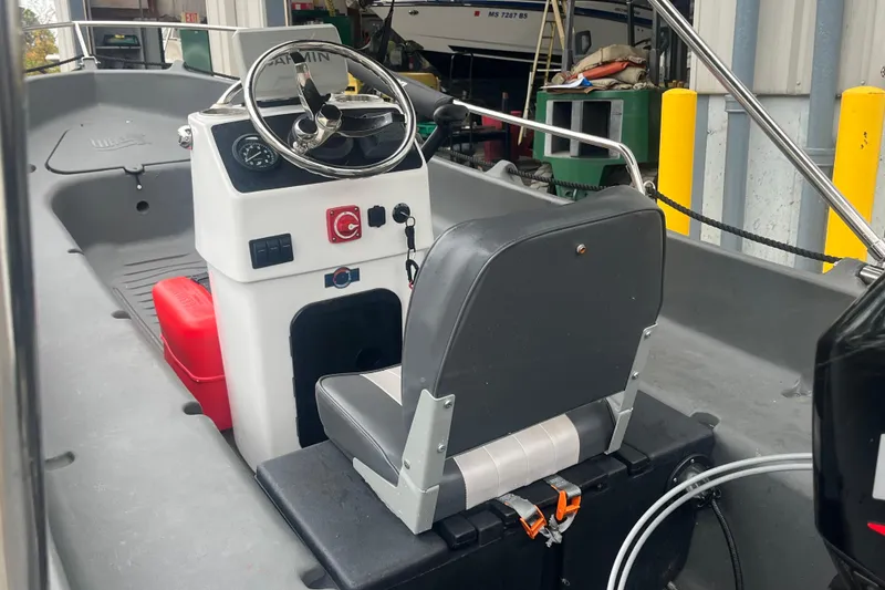 Slide: The Image of 2021 Whaly 435 R boat interior with steering console and seating. - 2