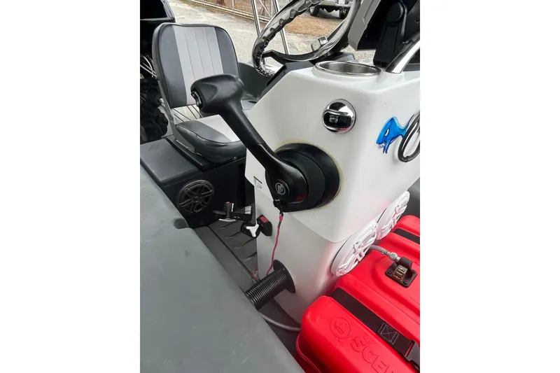 Slide: The Image of Control console of a 2021 Whaly 435 R boat with steering and throttle. - 9