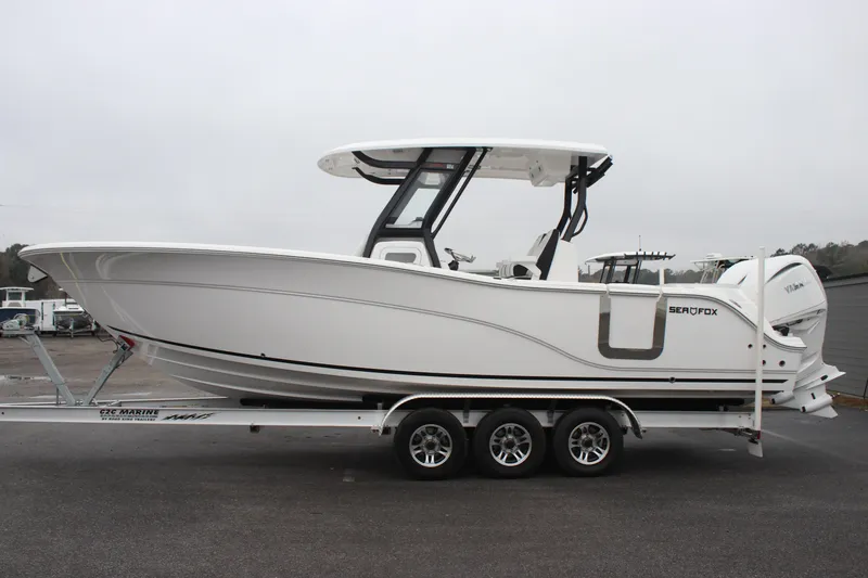 Slide: The Image of 2026 Sea Fox 288 Commander boat on trailer, side view, overcast sky. - 3
