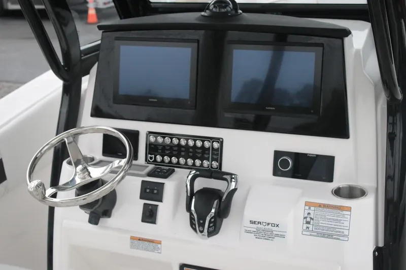 Slide: The Image of 2026 Sea Fox 288 Commander boat dashboard with dual screens and controls. - 6