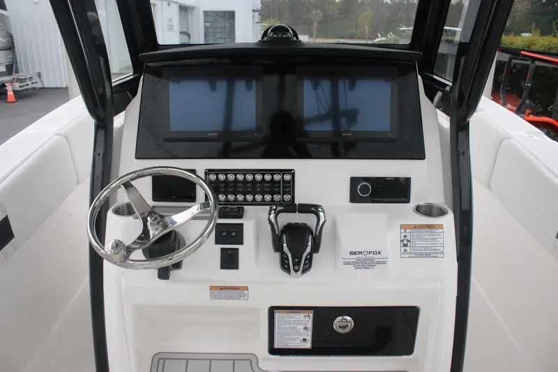 Slide: The Image of 2026 Sea Fox 288 Commander boat dashboard with steering wheel and controls. - 7