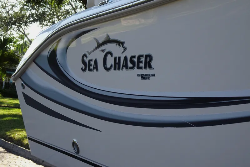 Slide: The Image of 2018 Sea Chaser 22 HFC boat with sleek design and logo detail. - 12