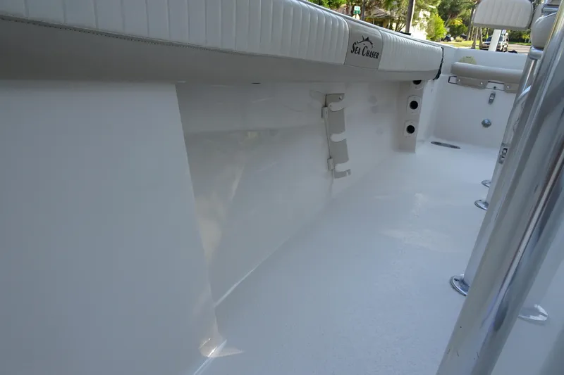 Slide: The Image of 2018 Sea Chaser 22 HFC boat interior, featuring sleek white design and seating. - 14