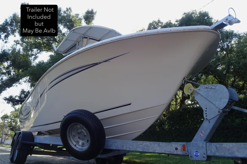 Slide: The Image of 2018 Sea Chaser 22 HFC boat on trailer, trees in background. - 19