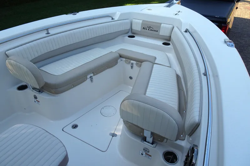 Slide: The Image of 2018 Sea Chaser 22 HFC boat interior with cushioned seating and cup holders. - 4
