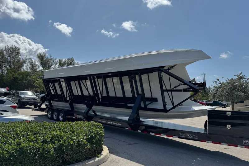 Slide: The Image of 2024 MTI 440X boat on trailer under clear blue sky. - 4