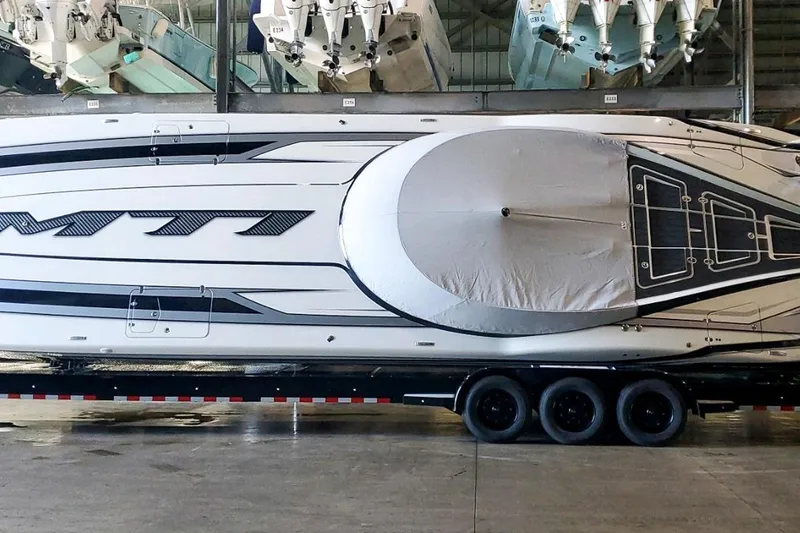 Slide: The Image of 2024 MTI 440X boat on trailer in storage facility, side view. - 5