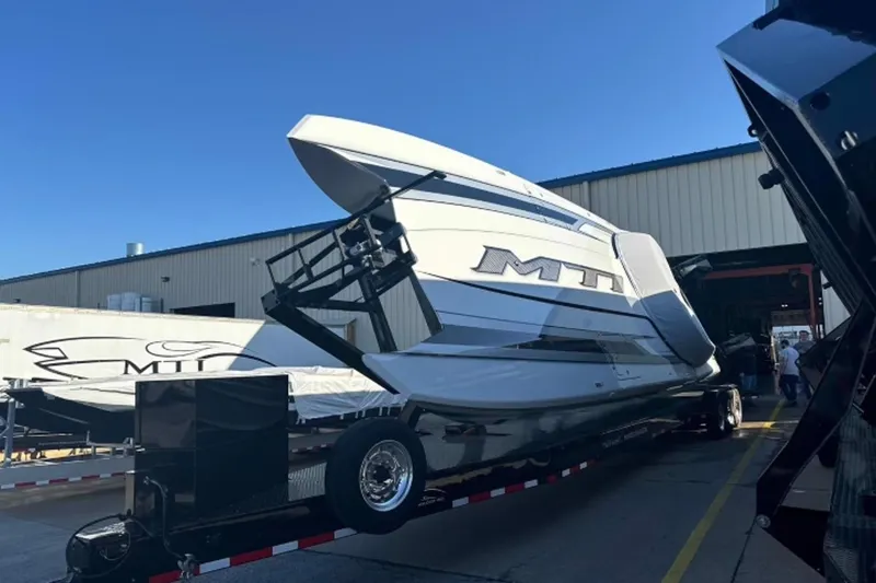 Slide: The Image of 2024 MTI 440X powerboat on trailer outside industrial building. - 8