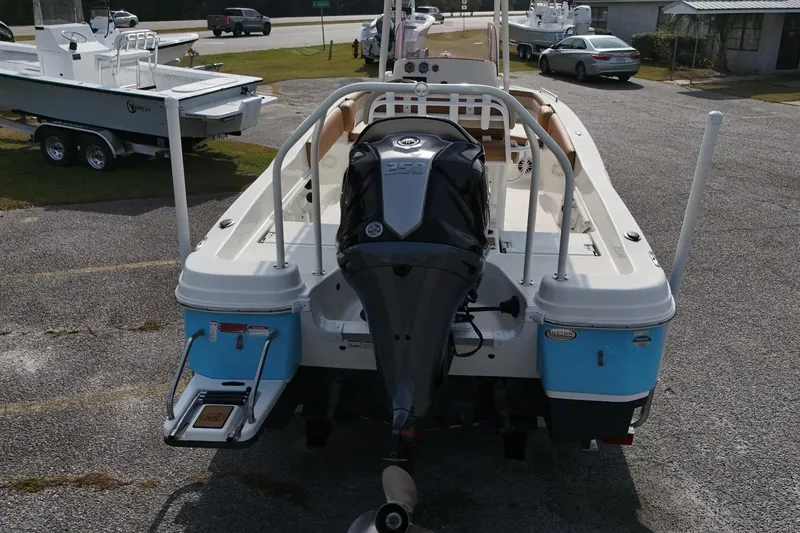 Slide: The Image of 2023 NauticStar 231 Hybrid boat with powerful outboard motor, parked on a lot. - 12