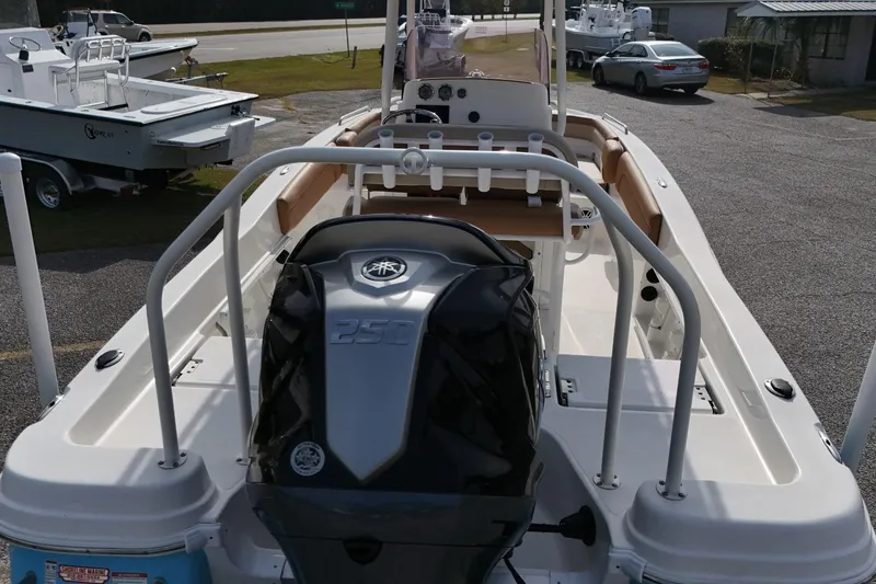 Slide: The Image of 2023 NauticStar 231 Hybrid boat with powerful 250 engine, parked outdoors. - 14