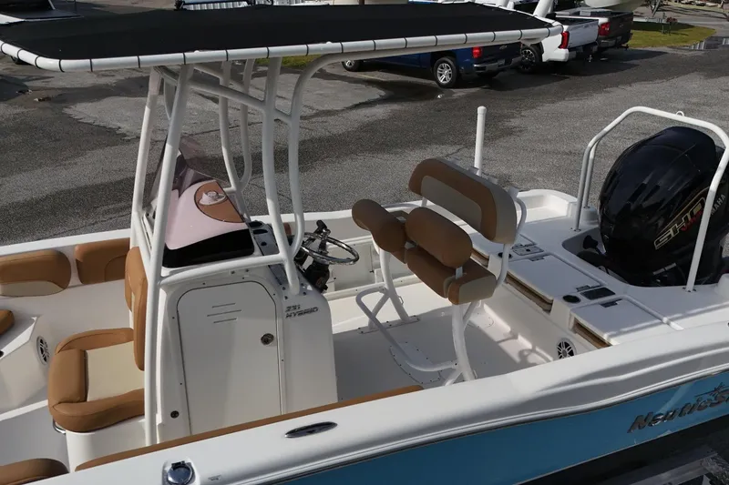 Slide: The Image of 2023 NauticStar 231 Hybrid boat with seating and Yamaha engine, docked outdoors. - 4