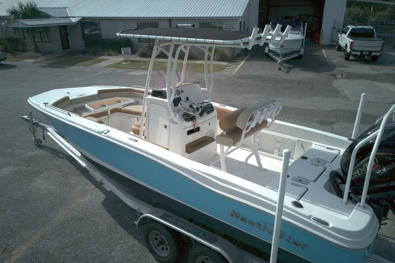 Slide: The Image of 2023 NauticStar 231 Hybrid boat on trailer, featuring sleek design and modern amenities. - 5