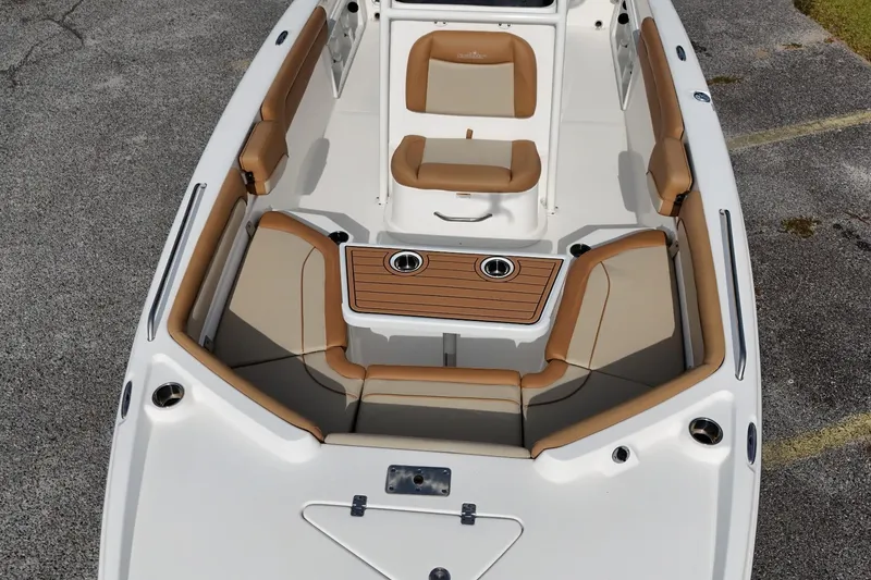 Slide: The Image of 2023 NauticStar 231 Hybrid boat interior with tan seating and wood accents. - 6