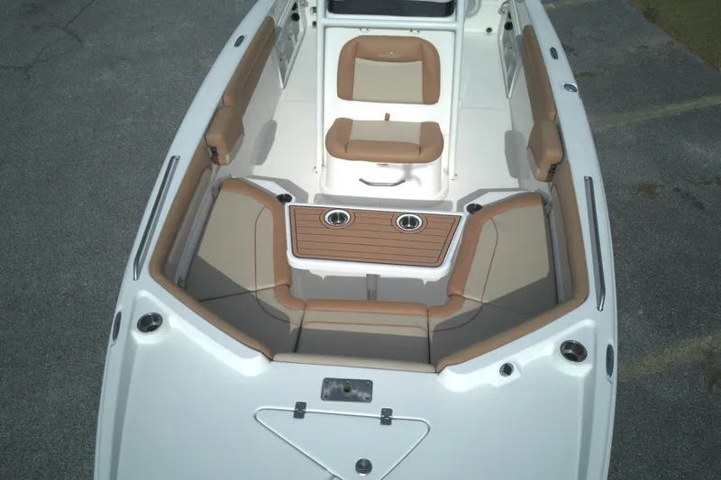Slide: The Image of 2023 NauticStar 231 Hybrid boat interior with tan seating and wood accents. - 7