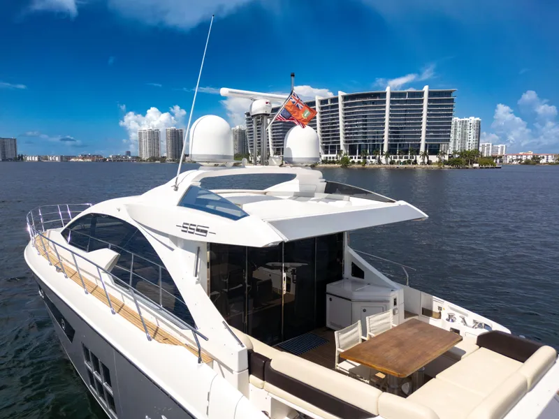 Slide: The Image of 2016 Azimut 55S yacht on water with modern buildings in the background. - 16